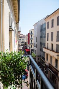 a view of a city street from a balcony at Little Palace in Cannes