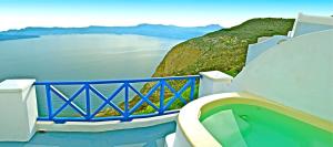 a blue and white balcony with a view of the water at Astarte Suites in Akrotiri