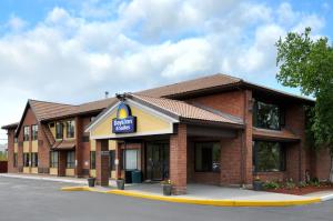 a brick building with a sign for a garage at Days Inn by Wyndham Utica in Utica