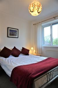 um quarto com uma cama grande e um cobertor vermelho em The Worthys em Bristol
