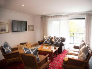 a living room with a couch and a table at 7 Ackermann Place Guest House in Stellenbosch