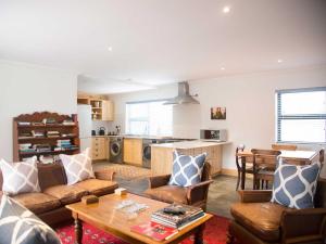 a living room with a couch and a table at 7 Ackermann Place Guest House in Stellenbosch