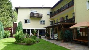 a large building with a yard with plants at Hotel Sonnleitn in Bodenmais