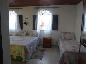 A bed or beds in a room at Casa Pontal Ilheus