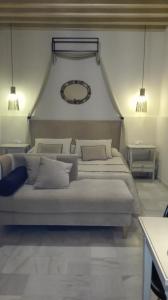 a bedroom with two beds and a mirror on the wall at Estudio Bizcocheros in Jerez de la Frontera