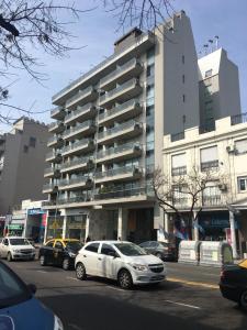 a parking lot with cars parked in front of a building at Sissi Apart in Buenos Aires