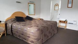 Postel nebo postele na pokoji v ubytování Coachman Motel