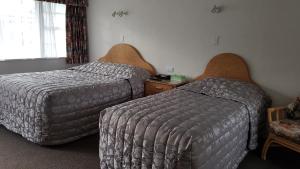 Postel nebo postele na pokoji v ubytování Coachman Motel