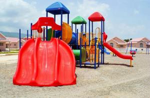 a playground with a slide in a park at Caymanas Estate beautiful 2 bedroom in Ellis Caymanas