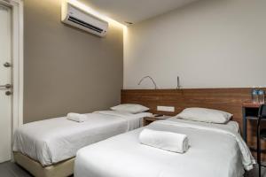 Postel nebo postele na pokoji v ubytování MAX Hotel Subang Jaya