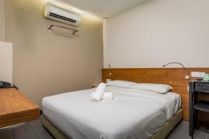 Postel nebo postele na pokoji v ubytování MAX Hotel Subang Jaya