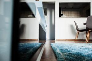 sala de estar con silla y alfombra azul en Apartament, en Radom