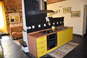 a kitchen with a sink and a stove top oven at Apartment Piazza XXV Aprile in Laigueglia