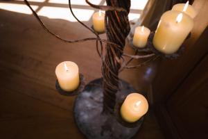 a group of candles in a vase on a table at Trikolonion Country Stemnitsa in Stemnitsa