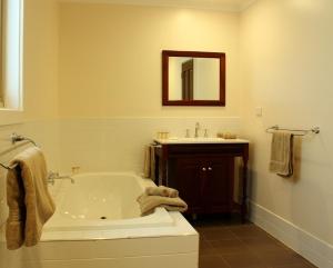 a white bathroom with a tub and a sink at Bungaree Station in Clare
