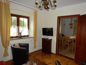 a living room with a television and a dining room at Ferienhaus Humer in Altmünster