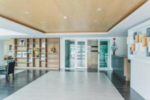 a living room with a table and a dining room at Ozone Condotel by Thawinan in Kata Beach