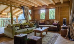 a living room with a couch and a table at Chalet Ferme des Amis in Les Gets