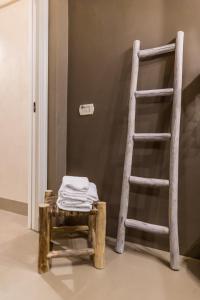 a wooden stool next to a ladder and a ladder at Borgo San Gaetano in Bernalda