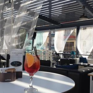 a drink sitting on a table in a restaurant at Primera Hotel in St. Paul's Bay