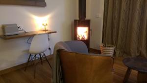 a living room with two chairs and a table and a fireplace at The Cellars At Heathcote II in Toolleen