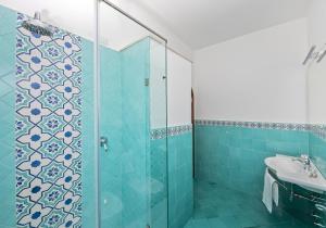 a bathroom with a shower and a sink at Hotel Pupetto in Positano