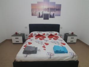 a bedroom with a bed with red roses on it at Casa Federica 1 in La Spezia