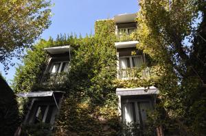 
a house with trees and bushes in front of it at Legado Mitico in Buenos Aires
