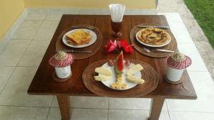 Tirtagangga的住宿－Alamku Bungalow，木桌,带两盘食物和纸杯蛋糕