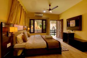 a bedroom with a large bed and a television at Kunwar Residency in Rishīkesh