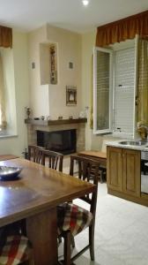 a kitchen with a table and chairs and a fireplace at Casa Rovere Perugia in Perugia