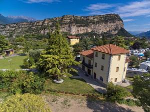 an aerial view of a house with a mountain in the background at Villa Torbole in Nago-Torbole