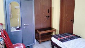 Postel nebo postele na pokoji v ubytování Akashadeepa Homestay
