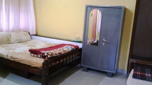 Postel nebo postele na pokoji v ubytování Akashadeepa Homestay