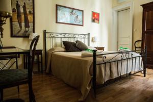 a bed sitting in a bedroom next to a wall at Casa Elide in Catania