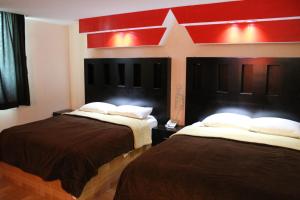 En eller flere senge i et værelse på Hotel San Rafael