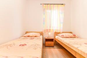 Postel nebo postele na pokoji v ubytování Apartments Zoricic