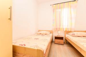 Postel nebo postele na pokoji v ubytování Apartments Zoricic