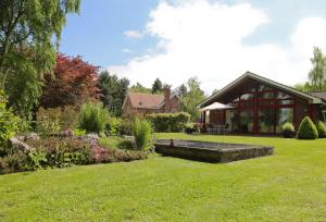 a house with a garden and a building at Surlingham Lodge Cottages in Norwich