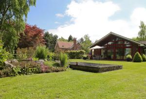 a house with a garden and a building at Surlingham Lodge Studio Large Family Cottage in Norwich