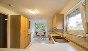 a kitchen with a sink and a table with chairs at Hotel am Wasen in Freiberg am Neckar