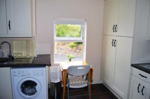 a kitchen with a small table and a window at Ash Tree Cottage in Bangor