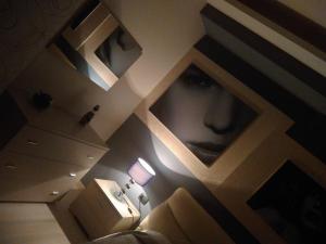a room with a picture of a mans face on the wall at Crocco D'Oro in Caltavuturo +9 photos