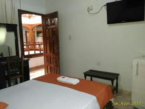 a bedroom with a bed and a table and a mirror at Hotel Arauca Colonial in Arauca