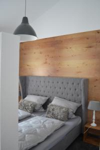 a bed with a wooden headboard and two pillows at Walnusshof Bad Salzungen in Bad Salzungen