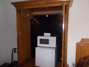 a microwave on top of a refrigerator in a room at Atomic Inn Beatty Near Death Valley in Beatty