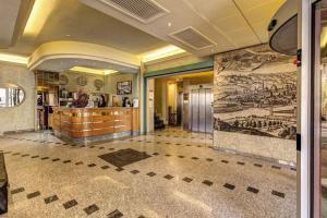 a lobby with a large mural on the wall at Hotel Europa in Signa