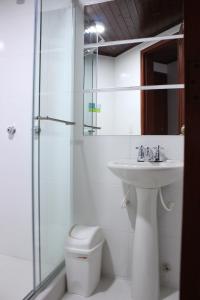 a bathroom with a sink and a toilet and a shower at Hotel Suite Santa Rosa in Santa Rosa de Cabal