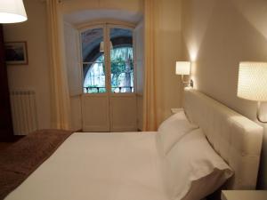 a bedroom with a white bed and a window at IL PORTICO - La Spezia to go 5Terre in La Spezia