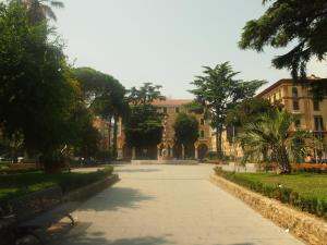 a park with a bench in front of a building at IL PORTICO - La Spezia to go 5Terre in La Spezia